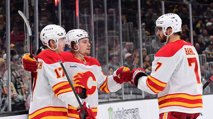 Yegor Sharangovich, Connor Zary and Kevin Bahl of the Calgary Flames
