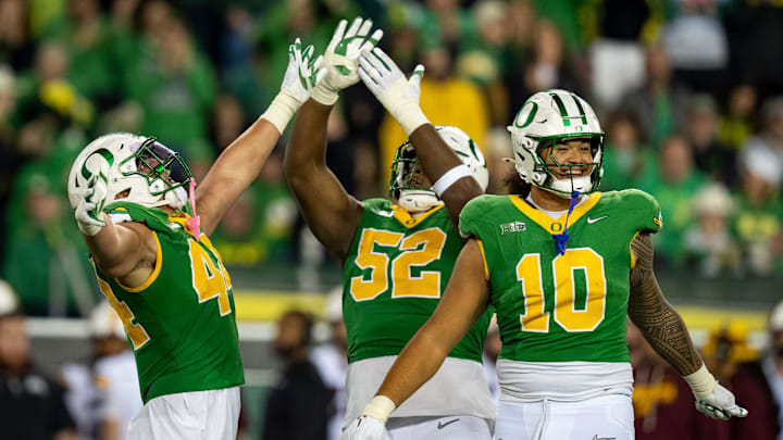 Oregon outside linebacker Teitum Tuioti, left, defensive lineman A'Mauri Washington and outside linebacker Matayo Uiagalelei celebrate a sack by Tuioti as the Oregon Ducks host the Minnesota Golden Gophers on Nov. 14, 2025, at Autzen Stadium in Eugene, Oregon.