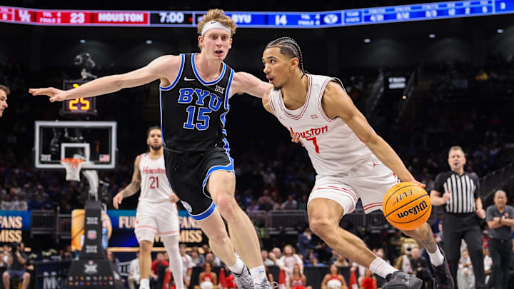 Mar 14, 2025; Kansas City, MO, USA; Houston Cougars guard Milos Uzan (7) drives to the basket around Brigham Young Cougars forward Richie Saunders (15) during the first half at T-Mobile Center. Mandatory Credit: William Purnell-Imagn Images
