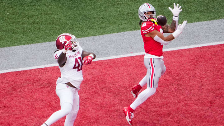 Ohio State Buckeyes wide receiver Emeka Egbuka catches a touchdown pass against Indiana Hoosiers defender Lanell Carr Jr.