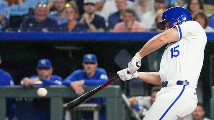 Sep 3, 2024; Kansas City, Missouri, USA; Kansas City Royals third baseman Paul DeJong (15) hits a one-run sacrifice against the Cleveland Guardians in the sixth inning at Kauffman Stadium. Mandatory Credit: Denny Medley-Imagn Images