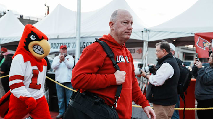 Louisville football coach Jeff Brohm leads the team as the Cards head to the locker room at the Cards March before the Louisville football game against Clemson at L&N Stadium Friday. Nov. 14, 2025