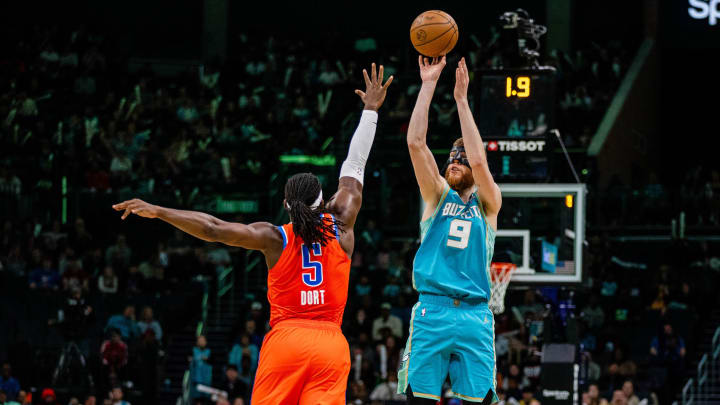 Apr 7, 2024; Charlotte, North Carolina, USA; Charlotte Hornets forward Davis Bertans (9) shoots over Oklahoma City Thunder guard Luguentz Dort (5) at Spectrum Center. Mandatory Credit: Scott Kinser-USA TODAY Sports