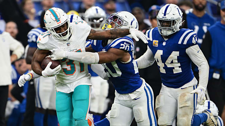 Oct 20, 2024; Indianapolis, Indiana, USA; Miami Dolphins running back Raheem Mostert (31) is tackled by Indianapolis Colts safety Nick Cross (20) during the second quarter at Lucas Oil Stadium.
