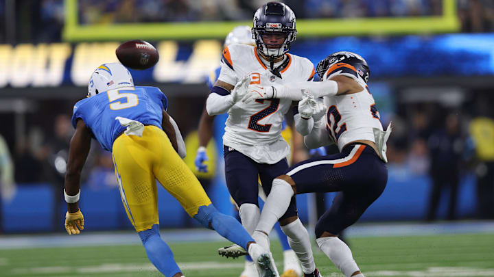 December 19, 2024, Inglewood, California, USA: Denver Broncos safety BRANDON JONES (22) and cornerback PATRICK SURTAIN II (2) challenge a catch attempt from Los Angeles Chargers wide receiver JOSH PALMER (5) during a NFL, American Football Herren, USA football game between the Denver Broncos and the Los Angeles Chargers at SoFi Stadium in Inglewood, California. December 19, 2024, Inglewood, California, USA: Denver Broncos safety BRANDON JONES (22) and cornerback PATRICK SURTAIN II (2) challenge a catch attempt from Los Angeles Chargers wide receiver JOSH PALMER (5) during a NFL, American Football Herren, USA football game between the Denver Broncos and the Los Angeles Chargers at SoFi Stadium in Inglewood, California.