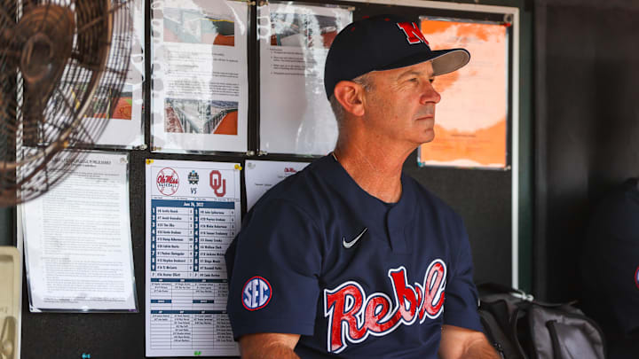 Jun 26, 2022; Omaha, NE, USA; Ole Miss Head Coach Mike Bianco sits in the dugout just before the first inning against the Oklahoma Sooners at Charles Schwab Field. Mandatory Credit: Jaylynn Nash-Imagn Images