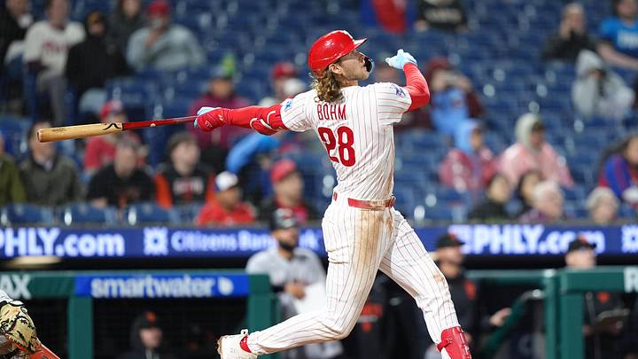 Apr 30, 2026; Philadelphia, Pennsylvania, USA; Philadelphia Phillies infielder Alec Bohm (28) hits a sacrifice fly against the San Francisco Giants in the tenth inning at Citizens Bank Park. 
