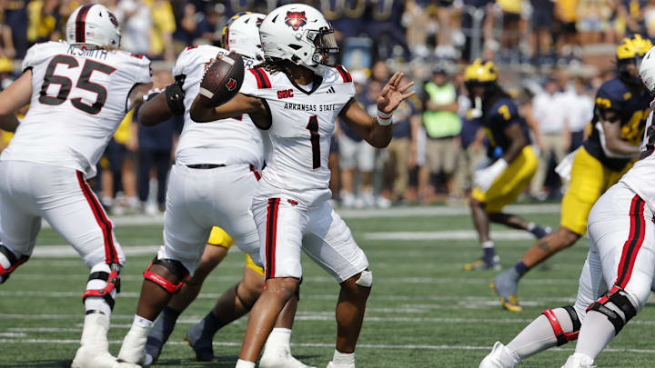 Sep 14, 2024; Ann Arbor, Michigan, USA;  Arkansas State Red Wolves quarterback Jaylen Raynor (1) throws against the Michigan Wolverines during the first half at Michigan Stadium.
