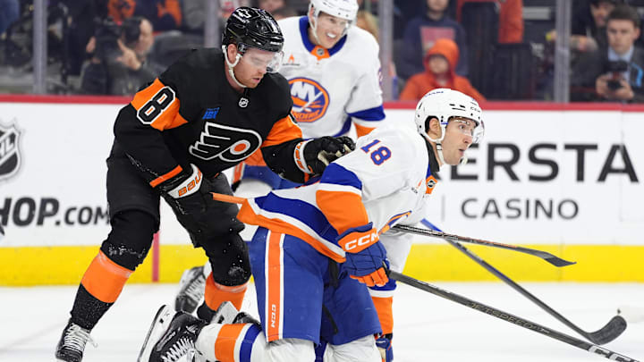 Apr 12, 2025; Philadelphia, Pennsylvania, USA; Philadelphia Flyers defenseman Cam York (8) attempts to free his stick against New York Islanders left wing Pierre Engvall (18) in the first period at Wells Fargo Center. Mandatory Credit: Kyle Ross-Imagn Images