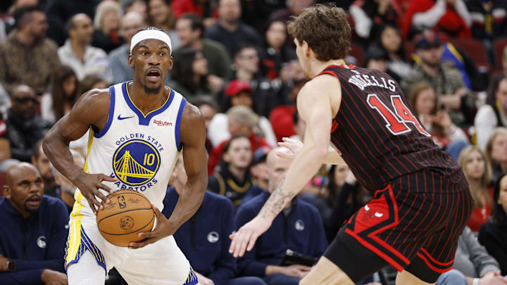Dec 7, 2025; Chicago, Illinois, USA; Chicago Bulls forward Matas Buzelis (14) defends against Golden State Warriors forward Jimmy Butler III (10)during the second half at United Center. Mandatory Credit: Kamil Krzaczynski-Imagn Images