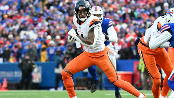 Jan 12, 2025; Orchard Park, New York, USA; Denver Broncos wide receiver Courtland Sutton (14) runs after making a catch in the fourth quarter of an AFC wild card game against the Buffalo Bills at Highmark Stadium. Mandatory Credit: Mark Konezny-Imagn Images