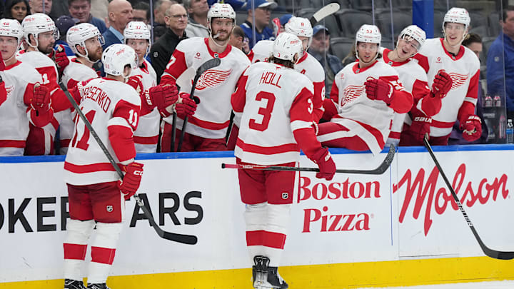 Apr 17, 2025; Toronto, Ontario, CAN; Detroit Red Wings defenseman Justin Holl (3) celebrate at the bench after scoring a goal against the Toronto Maple Leafs during the second period at Scotiabank Arena. Mandatory Credit: Nick Turchiaro-Imagn Images
