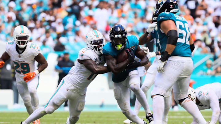 Jacksonville Jaguars running back Tank Bigsby (4) runs with the football against Miami Dolphins linebacker David Long Jr. (11) during the third quarter at Hard Rock Stadium in the 2024 season opener.