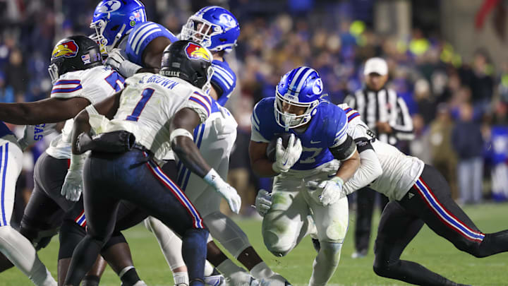 Nov 16, 2024; Provo, Utah, USA; Brigham Young Cougars running back LJ Martin (27) runs the ball against the Kansas Jayhawks during the fourth quarter at LaVell Edwards Stadium. Mandatory Credit: Rob Gray-Imagn Images