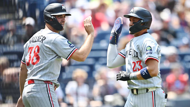 Aug 3, 2025; Cleveland, Ohio, USA; Minnesota Twins third baseman Royce Lewis (23) celebrates after scoring with right fielder Matt Wallner (38) during the first inning against the Cleveland Guardians at Progressive Field.
