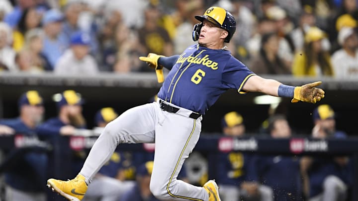 Sep 22, 2025; San Diego, California, USA; Milwaukee Brewers left fielder Isaac Collins (6) slides as he scores during the second inning against the San Diego Padres at Petco Park. Mandatory Credit: Denis Poroy-Imagn Images