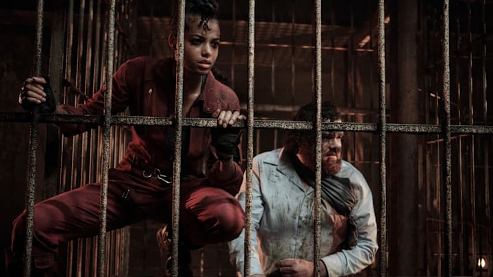 RESIDENT EVIL. (L to R) ELLA BALINSKA as JADE, TURLOUGH CONVERY as RICHARD BAXTER, ELLA BALINSKA as JADE in RESIDENT EVIL, TURLOUGH CONVERY as RICHARD BAXTER in RESIDENT EVIL. Cr. MARCOS CRUZ/NETFLIX © 2021