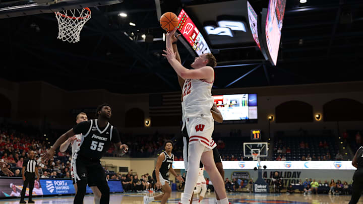Nov 27, 2025; San Diego, CA, USA; Wisconsin Badgers forward Austin Rapp (22) shoots the ball against Providence Friars during the second half at Jenny Craig Pavilion. 