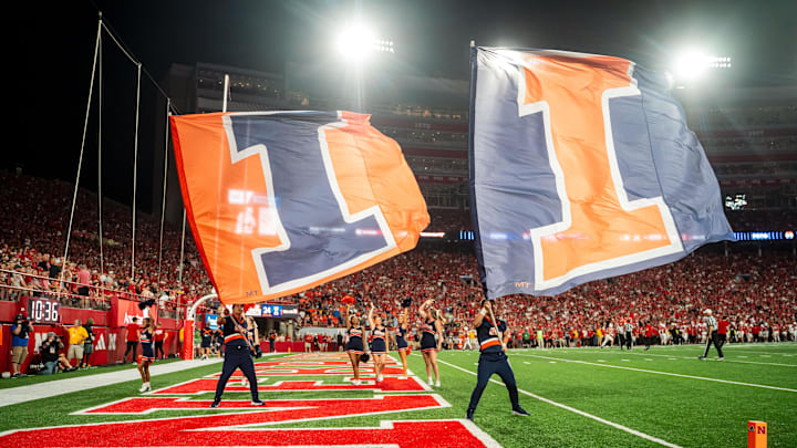 Sep 20, 2024; Lincoln, Nebraska, USA; Illinois Fighting Illini flags are waved after a touchdown against the Nebraska Cornhuskers during the fourth quarter at Memorial Stadium. Mandatory Credit: Dylan Widger-Imagn Images