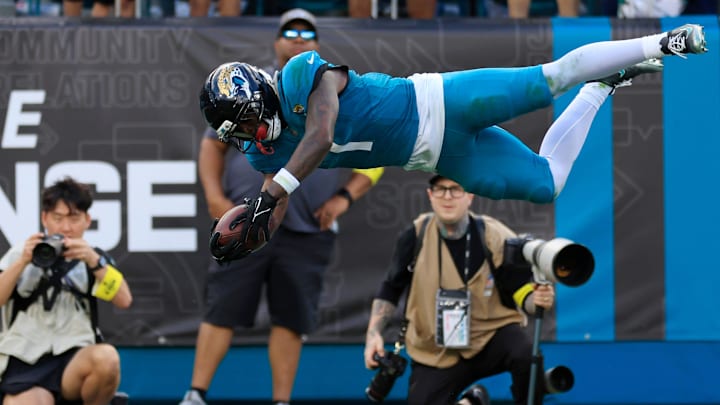 Jacksonville Jaguars running back Travis Etienne Jr. (1) leaps to score a rushing touchdown during the fourth quarter of an NFL football matchup at EverBank Stadium, Sunday, Dec. 14, 2025, in Jacksonville, Fla. The Jaguars defeated the Jets 48-20. [Corey Perrine/Florida Times-Union]
