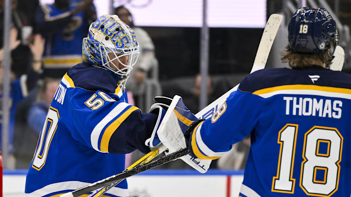 Feb 23, 2025; St. Louis, Missouri, USA;  St. Louis Blues goaltender Jordan Binnington (50) celebrates with center Robert Thomas (18) after the Blues defeated the Colorado Avalanche at Enterprise Center. Mandatory Credit: Jeff Curry-Imagn Images