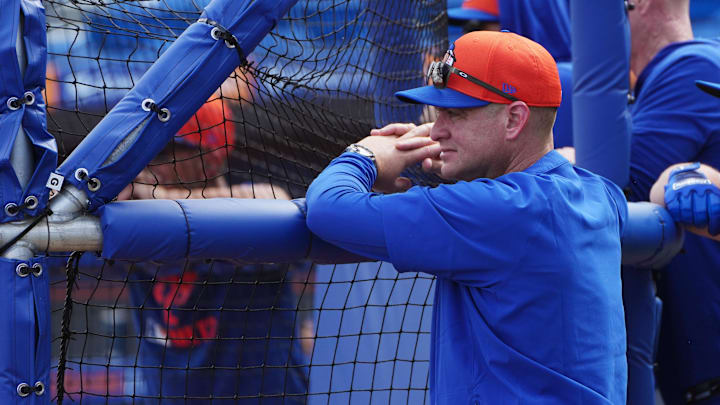Feb 13, 2025; Port St. Lucie, FL, USA; New York Mets manager Carlos Mendoza (64) watches batting practice during Spring Training. Mandatory Credit: Jim Rassol-Imagn Images