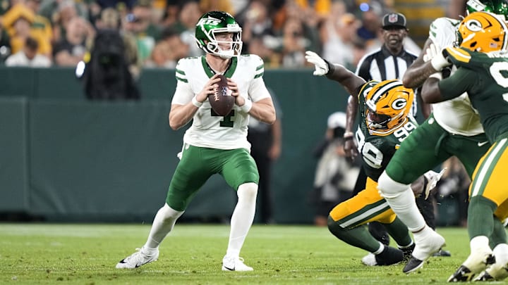 Aug 9, 2025; Green Bay, Wisconsin, USA;  New York Jets quarterback Brady Cook (4) looks to pass the ball during the second quarter against the Green Bay Packers at Lambeau Field. Mandatory Credit: Kayla Wolf-Imagn Images