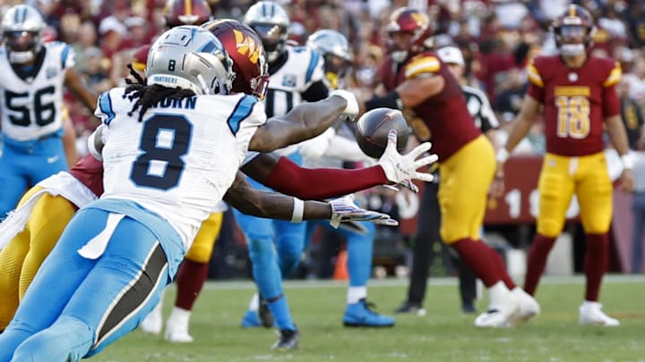 Oct 20, 2024; Landover, Maryland, USA; Carolina Panthers cornerback Jaycee Horn (8) breaks up a pass intended for Washington Commanders wide receiver Dyami Brown (2) during the second quarter at Northwest Stadium. Mandatory Credit: Geoff Burke-Imagn Images