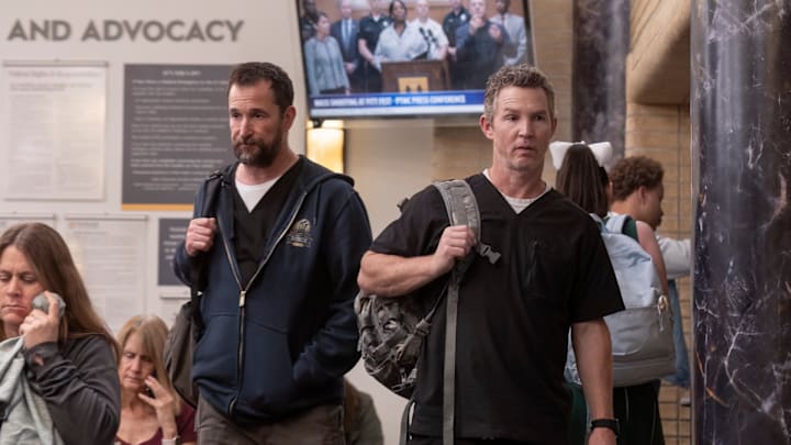 Noah Wyle and Shawn Hatosy in The Pitt. Robby and Abbott head out the pedestrian entrance to find a packed waiting room. (Warrick Page/MAX)