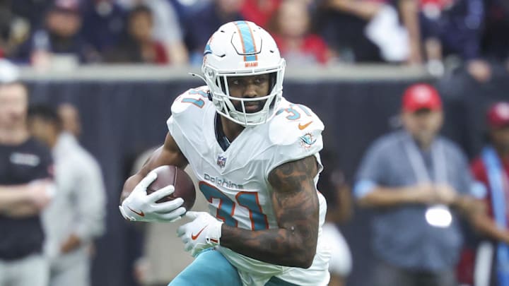 Dec 15, 2024; Houston, Texas, USA; Miami Dolphins running back Raheem Mostert (31) runs with the ball during the game against the Houston Texans at NRG Stadium. Mandatory Credit: Troy Taormina-Imagn Images