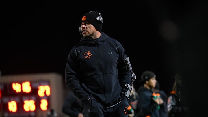 Apple Valley coach speaks to his team during the second quarter of their game against Oak Hills on Friday, October 18, 2024 at Newton T. Bass Stadium in Apple Valley. Oak Hills defeated Apple Valley 30-14 to remain first in the Mojave River League.