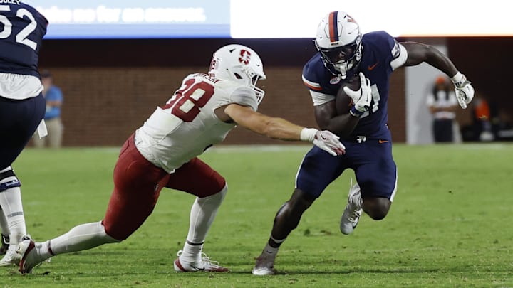 Sep 20, 2025; Charlottesville, Virginia, USA; Virginia Cavaliers running back Harrison Waylee (21) carries the ball as Stanford Cardinal linebacker Zach Johnson (38) attempts a tackle during the fourth quarter at Scott Stadium. Mandatory Credit: Geoff Burke-Imagn Images Sep 20, 2025; Charlottesville, Virginia, USA; Virginia Cavaliers running back Harrison Waylee (21) carries the ball as Stanford Cardinal linebacker Zach Johnson (38) attempts a tackle during the fourth quarter at Scott Stadium. Mandatory Credit: Geoff Burke-Imagn Images