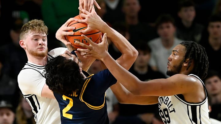 Vanderbilt’s Tyler Nickel, left, and Devin McGlockton (99) battle for the ball with California guard Andrej Stojakovic (2) during an NCAA college basketball game Wednesday, Nov. 13, 2024, in Nashville, Tenn.