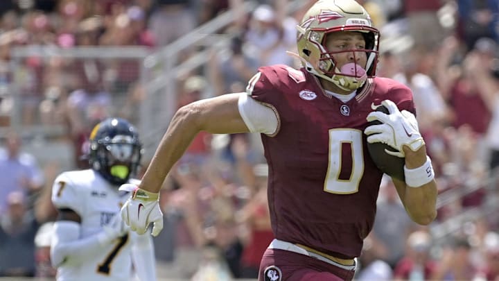 Sep 6, 2025; Tallahassee, Florida, USA; Florida State Seminoles wide receiver Duce Robinson (0) catches a touchdown during the first half against the East Texas A&M at Doak S. Campbell Stadium. Mandatory Credit: Melina Myers-Imagn Images