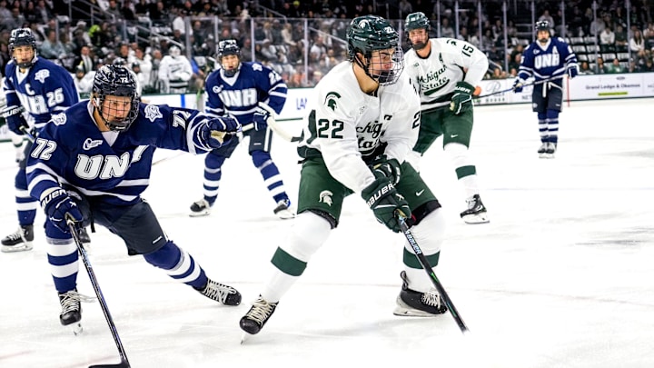 Michigan State's Porter Martone, right, moves the puck as New Hampshire's Conner de Haro closes in during the first period on Thursday, Oct. 9, 2025, at Munn Ice Arena in East Lansing.