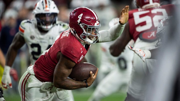 Alabama Crimson Tide quarterback Jalen Milroe (4) runs the ball as Auburn Tigers take on Alabama Crimson Tide at Bryant-Denny Stadium in Tuscaloosa, Ala., on Saturday, Nov. 30, 2024. Alabama Crimson Tide defeated Auburn Tigers 28-14. Alabama Crimson Tide quarterback Jalen Milroe (4) runs the ball as Auburn Tigers take on Alabama Crimson Tide at Bryant-Denny Stadium in Tuscaloosa, Ala., on Saturday, Nov. 30, 2024. Alabama Crimson Tide defeated Auburn Tigers 28-14.
