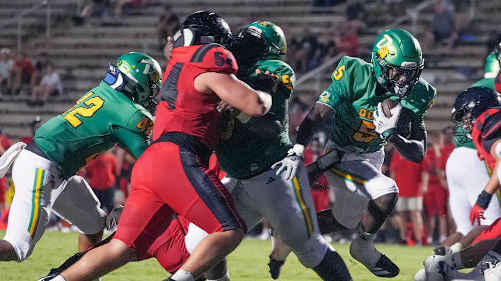 DeLand's Taihj Moore (5) runs up the middle to score a second-quarter touchdown against New Smyrna Beach on Aug. 29. Last week, he scored three TDs to lead the Bulldogs past Merritt Island, 57-51.