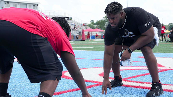 Trey Smith shows a camp attendant proper lineman stance during Trey Smith's football camp hosted at his alma mater University School of Jackson in Jackson, Tenn., on Saturday, June. 21, 2025. Trey Smith shows a camp attendant proper lineman stance during Trey Smith's football camp hosted at his alma mater University School of Jackson in Jackson, Tenn., on Saturday, June. 21, 2025.