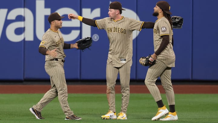 Sep 17, 2025; New York City, New York, USA; San Diego Padres left fielder Ramon Laureano (5) celebrates with center fielder Jackson Merrill (3) and right fielder Fernando Tatis Jr. (23) after defeating the New York Mets at Citi Field. Mandatory Credit: Vincent Carchietta-Imagn Images