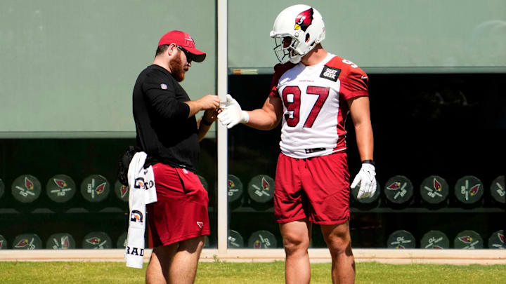 Arizona Cardinals outside linebacker Cameron Thomas (97) gets his hand taped during minicamp at the