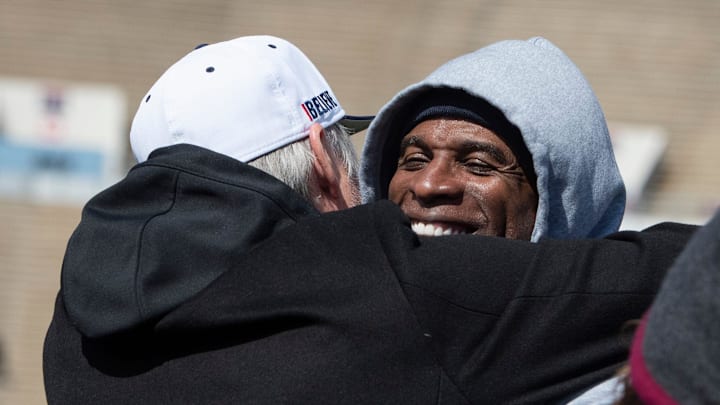 Deion Sanders is surprised by Rich Dalrymple, senior vice president of public relations and communication for the Dallas Cowboys
