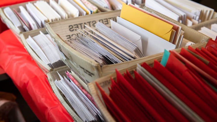 Stamped envelopes sit ready for mailing in Loveland, Colo.