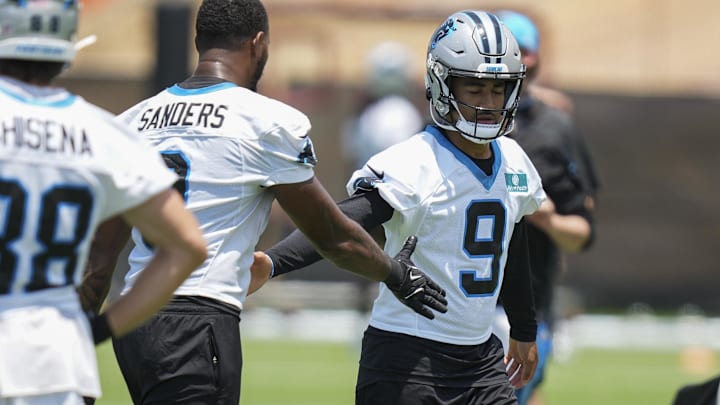 Jun 11, 2025; Charlotte, NC, USA; Carolina Panthers quarterback Bryce Young (9) high fives with Carolina Panthers tight end Ja'Tavion Sanders (0) during minicamp at Bank of America Stadium. Mandatory Credit: Jim Dedmon-Imagn Images