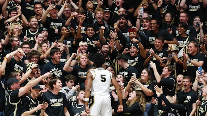 Purdue Boilermakers guard Myles Colvin (5) jumps into the crowd to celebrate with the student section 
