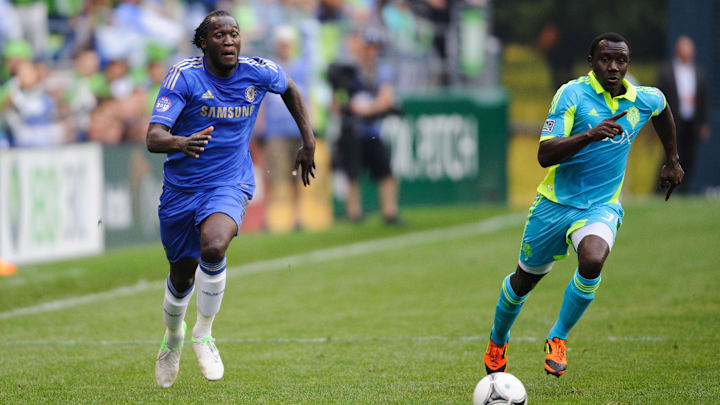 Jul 18, 2012; Seattle, WA, USA; Chelsea FC forward Romelu Lukaku (18) and Seattle Sounders FC defender Jhon Kennedy Hurtado (34) both chase the ball during the 1st half at CenturyLink Field. Chelsea FC defeated Seattle 4-2. Mandatory Credit: Steven Bisig-Imagn Images
