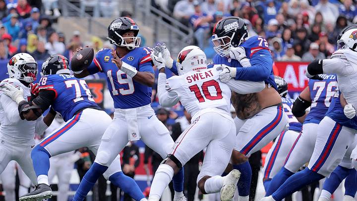Oct 4, 2026; East Rutherford, New Jersey, USA; New York Giants quarterback Jameis Winston (19) looks to pass under pressure from Arizona Cardinals linebacker Josh Sweat (10) during the second quarter at MetLife Stadium. Mandatory Credit: Brad Penner-Imagn Images