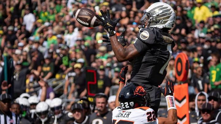 Oregon Ducks wide receiver Dakorien Moore hauls in a touchdown pass under cover from Oregon State Beavers defensive back Jalil Tucker as the Oregon Ducks host the Oregon State Beavers Sept. 20, 2025, at Autzen Stadium in Eugene, Oregon.