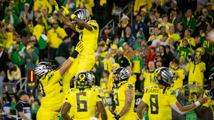 Oregon Ducks wide receiver Evan Stewart is thrown into the air after catching a touchdown reception as the Ducks host the Spartans Friday, Oct. 4, 2024 at Autzen Stadium in Eugene, Ore.