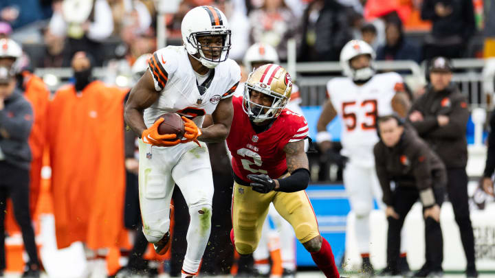 Oct 15, 2023; Cleveland, Ohio, USA; Cleveland Browns wide receiver Amari Cooper (2) runs the ball as San Francisco 49ers cornerback Deommodore Lenoir (2) pulls him down from behind during the fourth quarter at Cleveland Browns Stadium. Mandatory Credit: Scott Galvin-USA TODAY Sports