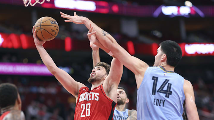 Oct 25, 2024; Houston, Texas, USA; Houston Rockets center Alperen Sengun (28) shoots the ball as Memphis Grizzlies center Zach Edey (14) defends during the fourth quarter at Toyota Center. Mandatory Credit: Troy Taormina-Imagn Images